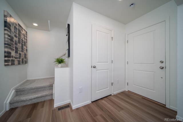 interior space with wood finished floors, visible vents, and baseboards