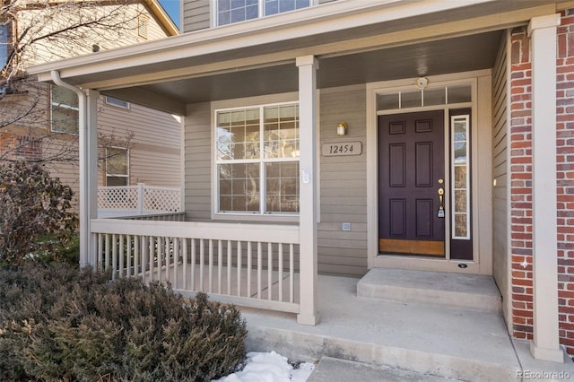 view of exterior entry with covered porch