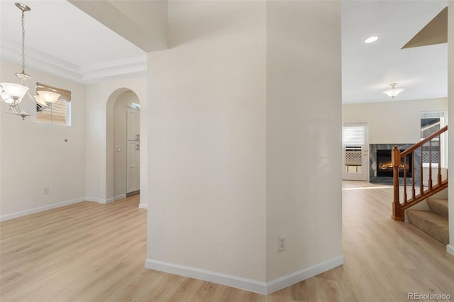 hallway with a chandelier and light hardwood / wood-style flooring