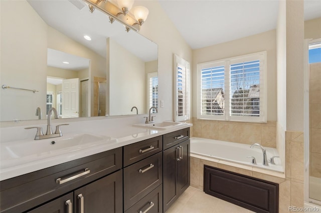 bathroom with tile patterned flooring, vanity, vaulted ceiling, and plus walk in shower