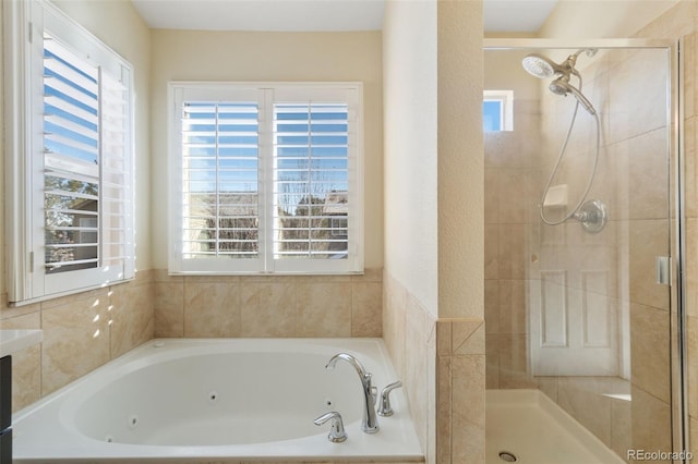 bathroom featuring separate shower and tub and plenty of natural light