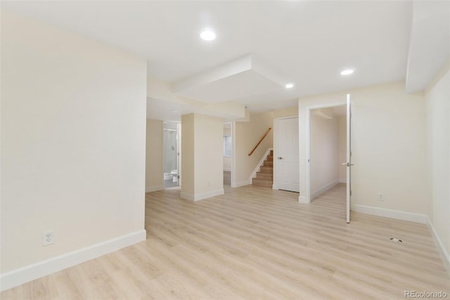 basement with light hardwood / wood-style flooring