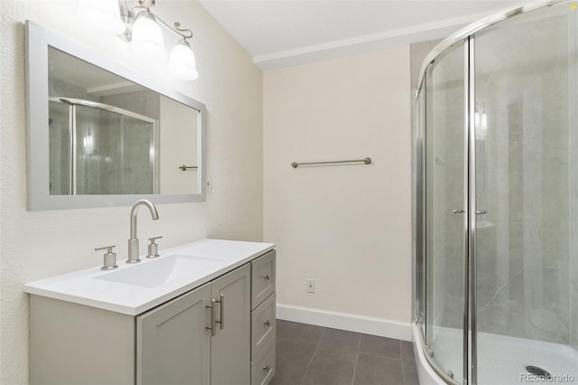 bathroom with tile patterned flooring, vanity, and a shower with door