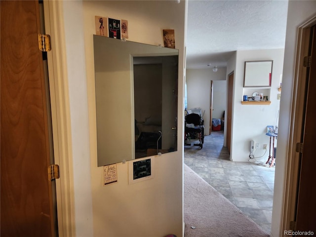 hallway featuring a textured ceiling