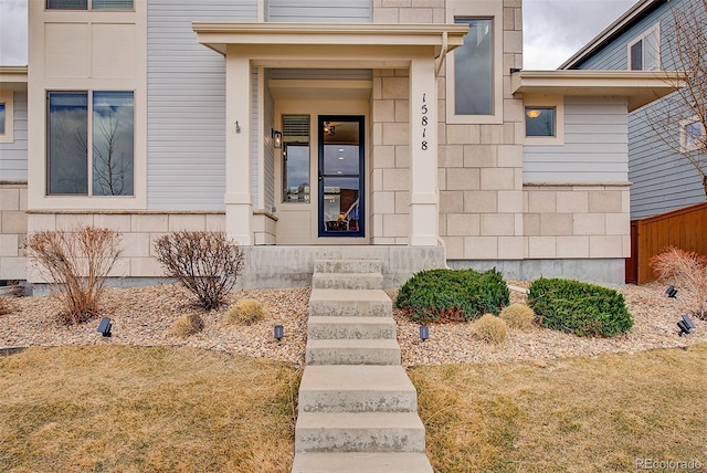 entrance to property featuring stone siding