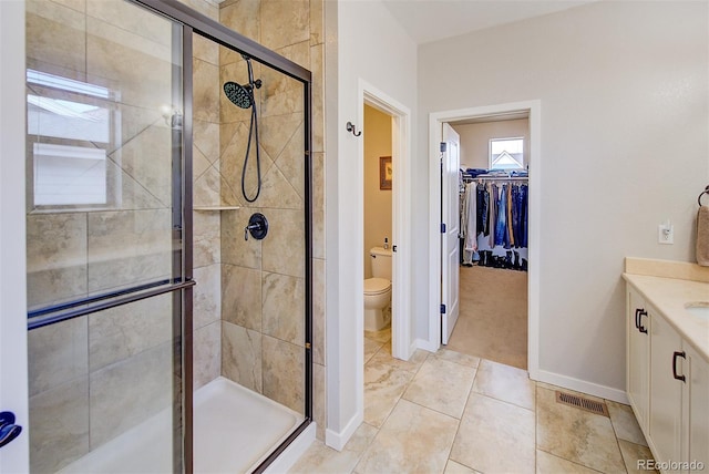 full bath with visible vents, toilet, a shower stall, and vanity