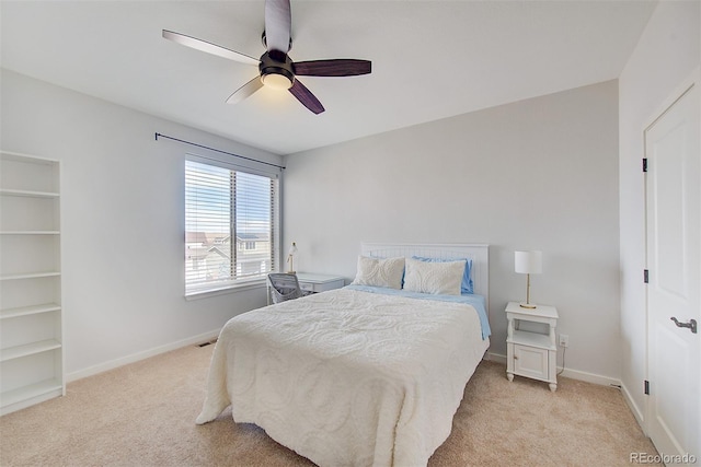 bedroom with baseboards, a ceiling fan, and light colored carpet