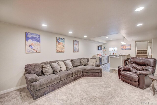 living room featuring baseboards, carpet, stairs, and recessed lighting