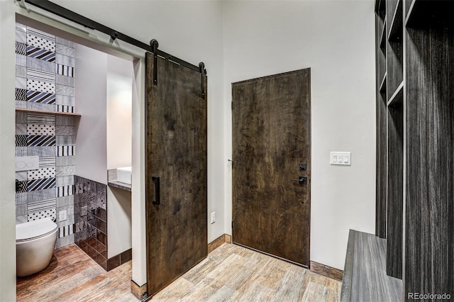 133 Adams Way, Breckenridge, CO 80424 - entrance foyer featuring wood finished floors, a barn door, and baseboards