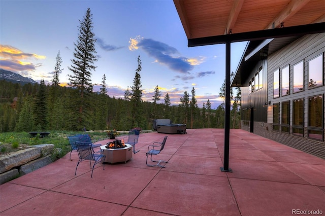 133 Adams Way, Breckenridge, CO 80424 - patio terrace at dusk featuring a fire pit, a patio, and a hot tub