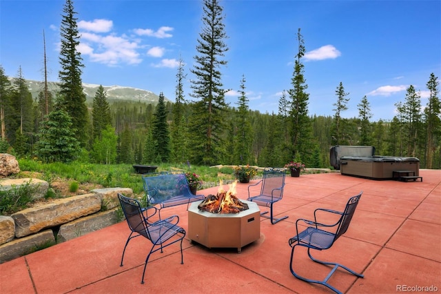 133 Adams Way, Breckenridge, CO 80424 - view of patio / terrace featuring a hot tub, a view of trees, and a fire pit