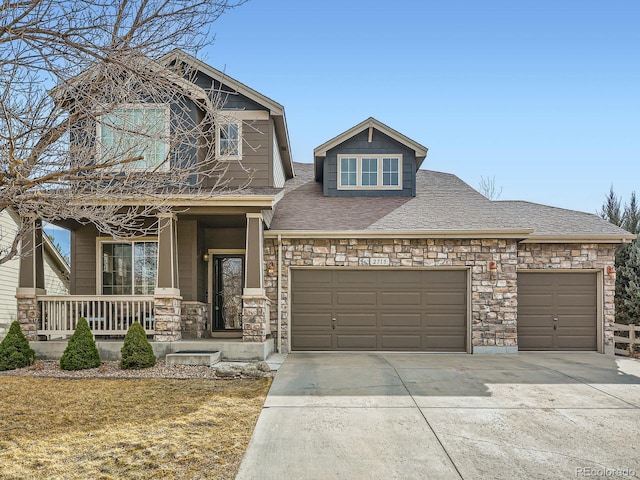 craftsman inspired home featuring concrete driveway, an attached garage, and covered porch