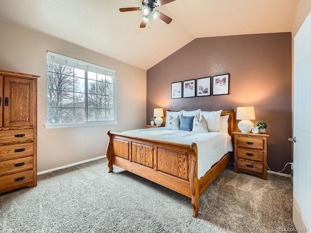 bedroom with carpet flooring, ceiling fan, baseboards, and vaulted ceiling