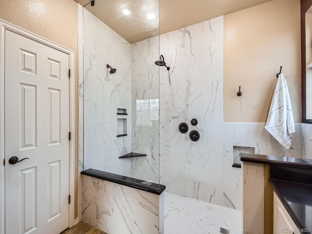 full bath featuring a marble finish shower