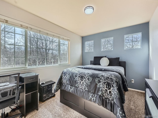 carpeted bedroom featuring baseboards