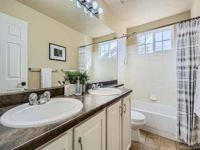 full bathroom with tile patterned floors, toilet, shower / tub combo, and a sink