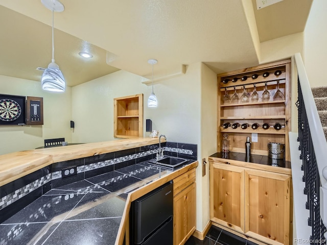 kitchen featuring a sink, decorative light fixtures, and open shelves