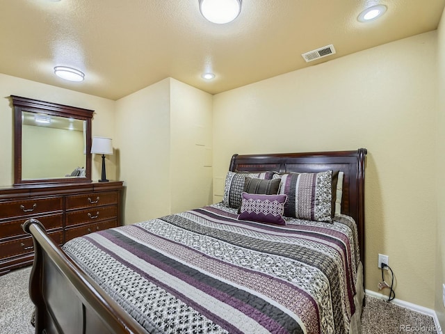 bedroom featuring visible vents, baseboards, carpet flooring, recessed lighting, and a textured ceiling