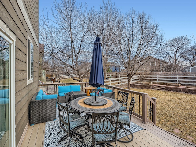 deck featuring outdoor lounge area and a fenced backyard