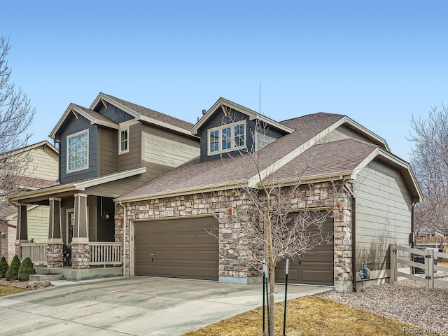 craftsman inspired home with stone siding, covered porch, concrete driveway, and an attached garage