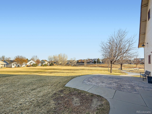 view of yard featuring a residential view and a patio area