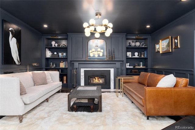 living room with ornamental molding, a fireplace with flush hearth, and built in features