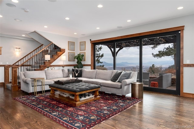 living area featuring stairs, recessed lighting, a mountain view, and wood finished floors