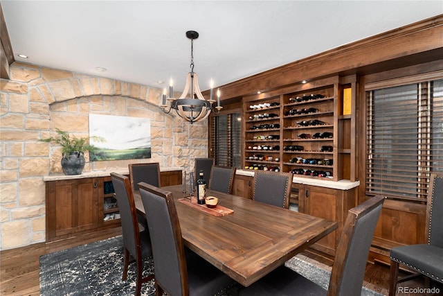 wine cellar featuring an inviting chandelier and wood finished floors