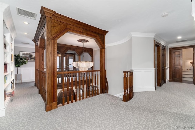 corridor featuring visible vents, carpet flooring, and ornamental molding