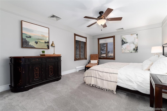 carpeted bedroom with ceiling fan, a baseboard radiator, visible vents, and baseboards