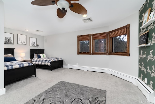 carpeted bedroom with a ceiling fan, visible vents, and baseboards