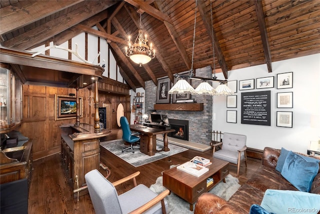 living area with wood ceiling, a fireplace, beam ceiling, and wood finished floors