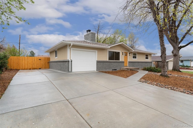 6448 Ingalls Ct, Arvada, CO 80003 - ranch-style home with a chimney, brick siding, fence, a garage, and concrete driveway