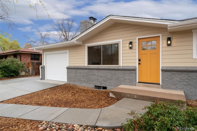6448 Ingalls Ct, Arvada, CO 80003 - entrance to property featuring a garage, a chimney, and driveway