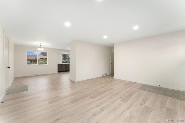 6448 Ingalls Ct, Arvada, CO 80003 - unfurnished living room featuring baseboards, light wood-style floors, visible vents, and recessed lighting