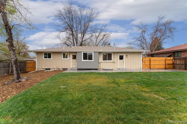 6448 Ingalls Ct, Arvada, CO 80003 - back of property with a yard, a patio, and a fenced backyard