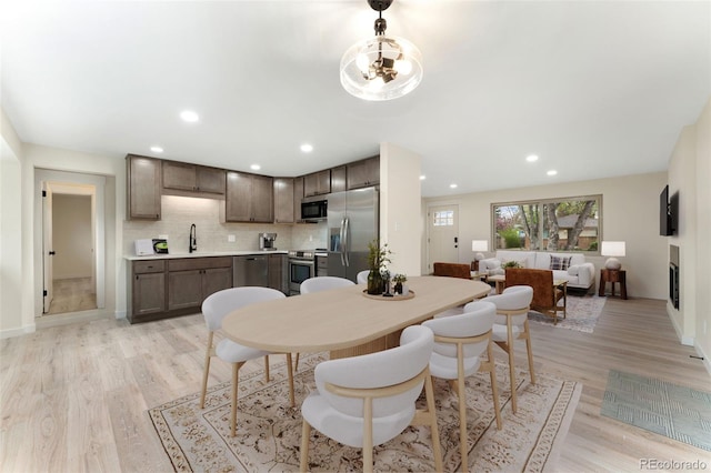 6448 Ingalls Ct, Arvada, CO 80003 - dining room with light wood-style floors, baseboards, and recessed lighting