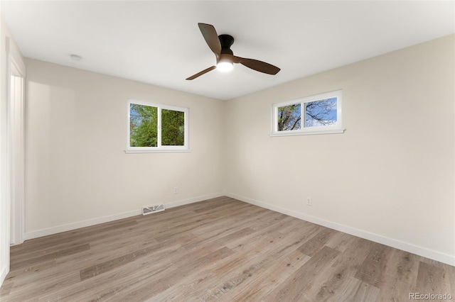 6448 Ingalls Ct, Arvada, CO 80003 - unfurnished room with baseboards, a ceiling fan, visible vents, and light wood-style floors
