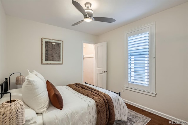 bedroom with baseboards, ceiling fan, and dark wood-style flooring