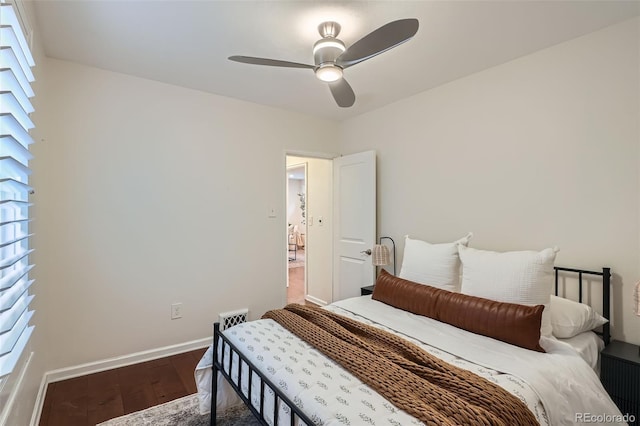 bedroom with baseboards, a ceiling fan, and wood finished floors