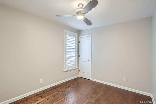 unfurnished room with baseboards, a ceiling fan, and dark wood-style flooring