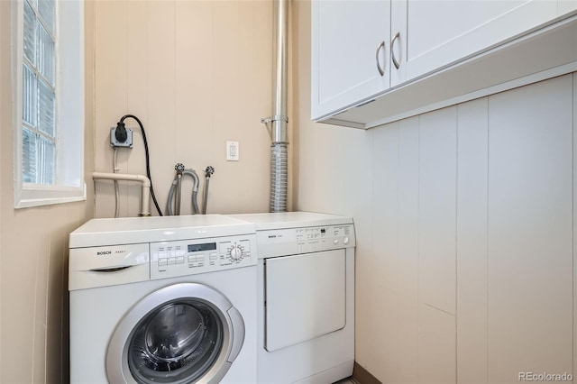 laundry room with washing machine and dryer and cabinet space