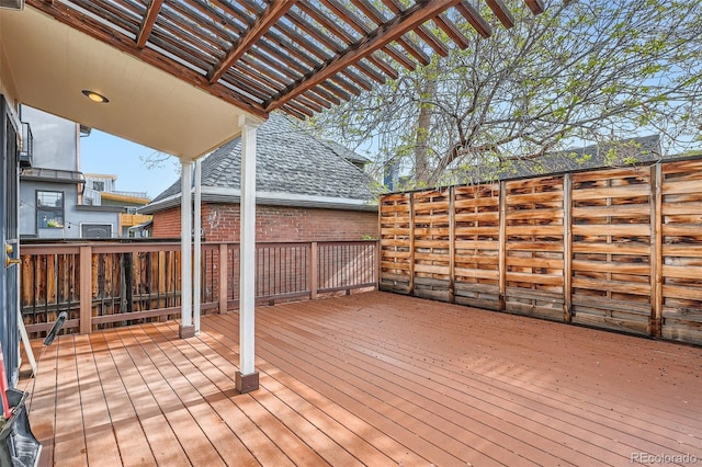 wooden terrace featuring fence and a pergola
