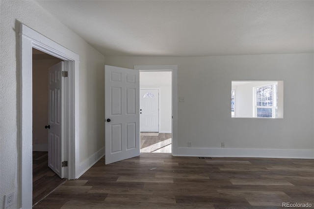 unfurnished room with wood finished floors and baseboards