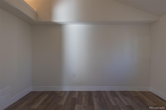 spare room with dark wood-style floors, baseboards, and visible vents