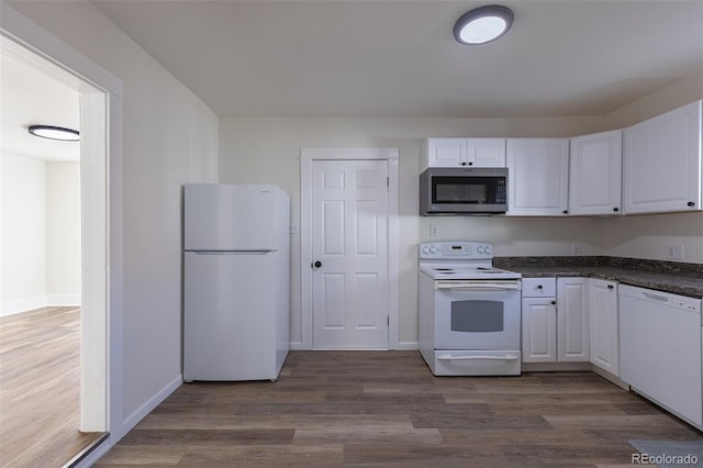 kitchen featuring white appliances, white cabinets, and dark wood finished floors