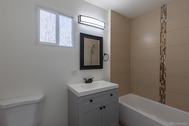 full bathroom with shower / bathtub combination, a textured wall, vanity, and toilet