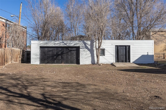 view of outdoor structure featuring an outbuilding and fence