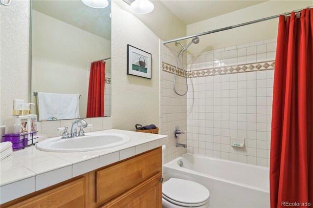 4061 Nordland Trl, Castle Rock, CO 80109 - bathroom featuring vanity, toilet, a textured wall, and shower / bath combination with curtain