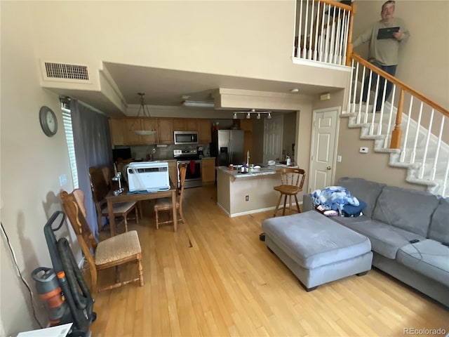 21300 E 42nd Ave, Denver, CO 80249 - living area with light wood-type flooring and stairway